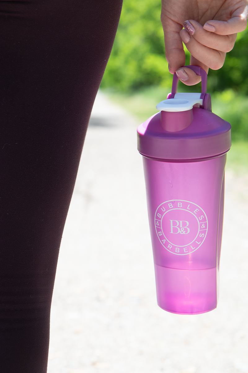 Woman holding pink shaker cup